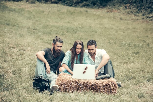 Serious friends use laptop computer