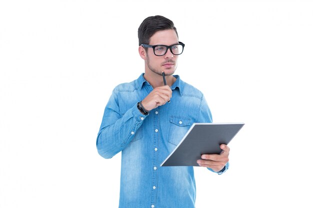 Serious geeky hipster holding book and pen