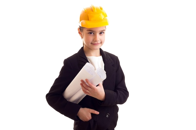 Serious little girl with long brown ponytail in Tshirt and jacket holding pen and black folder