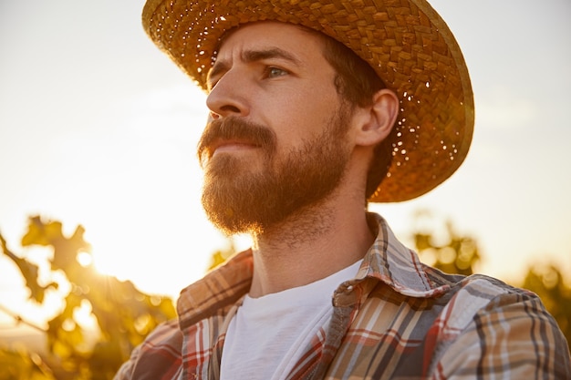 Serious male farmer at sunset