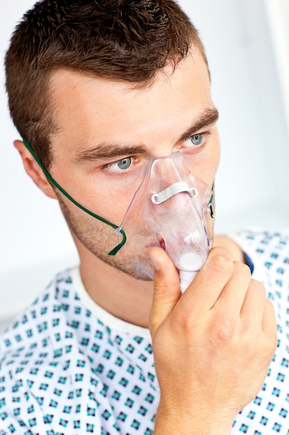 Serious male patient with a mask looking to the side