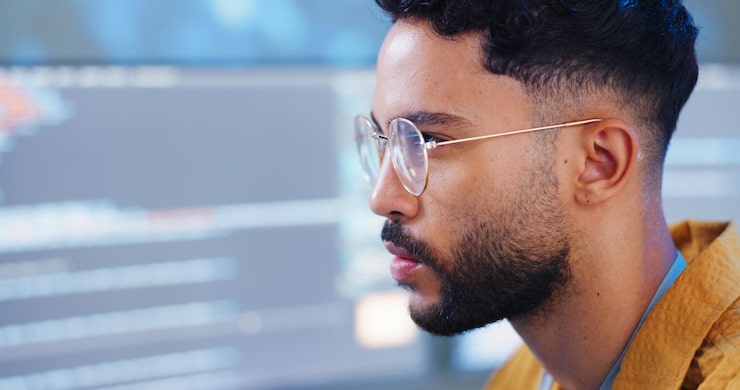 Photo serious man and coding with computer for cybersecurity developer update and app upgrade thinking working and coder tech with programmer search and software system planning with office monitor