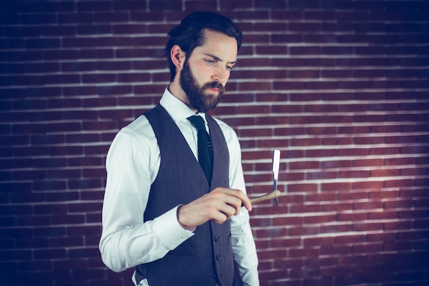 Serious man holding razor