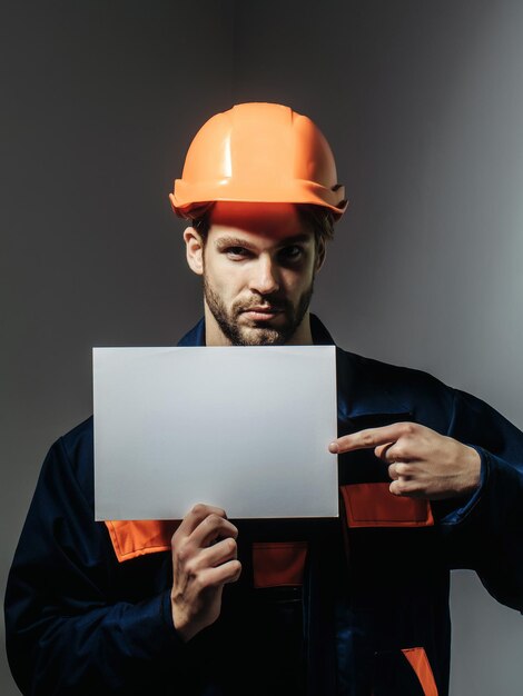 Serious man keeps blank paper