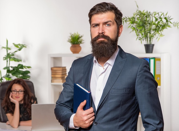 Foto datore di lavoro professionale uomo serio in tuta stand davanti donna dipendente in ufficio professionalità