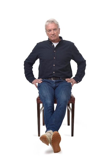 Serious man sitting on a chair on white background