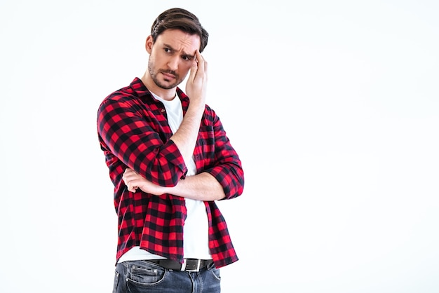 The serious man standing on the white background