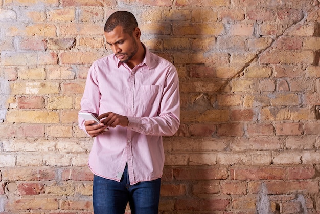 Serious man using smartphone