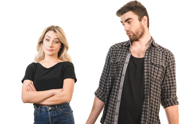 The serious man and woman standing on the white background