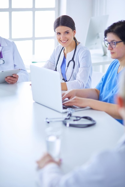 Serious medical team discussing patient's case in a bright office