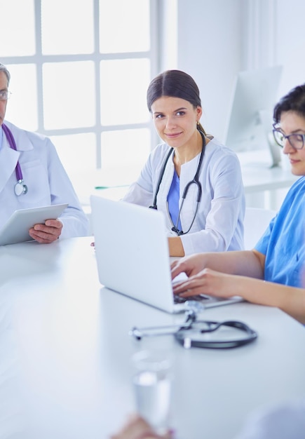 Serious medical team discussing patient's case in a bright office