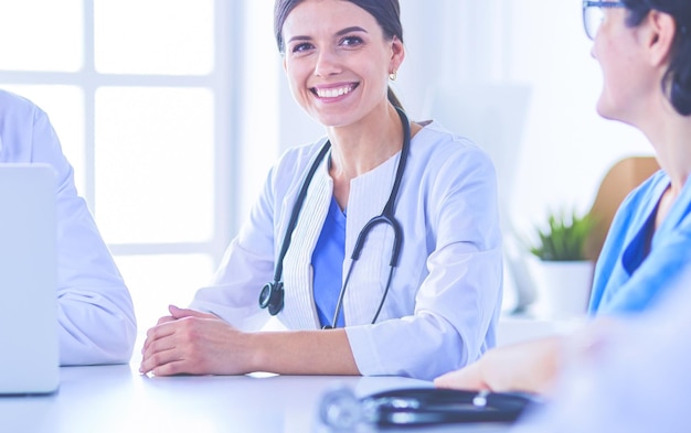 Serious medical team discussing patient's case in a bright office