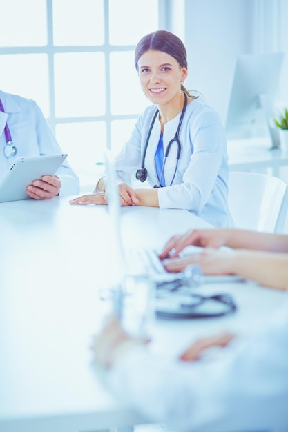 Serious medical team discussing patient's case in a bright office