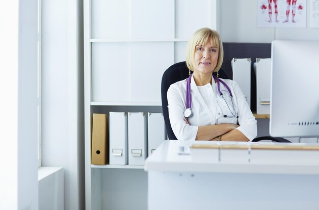 Serious medical team using a laptop in a bright office