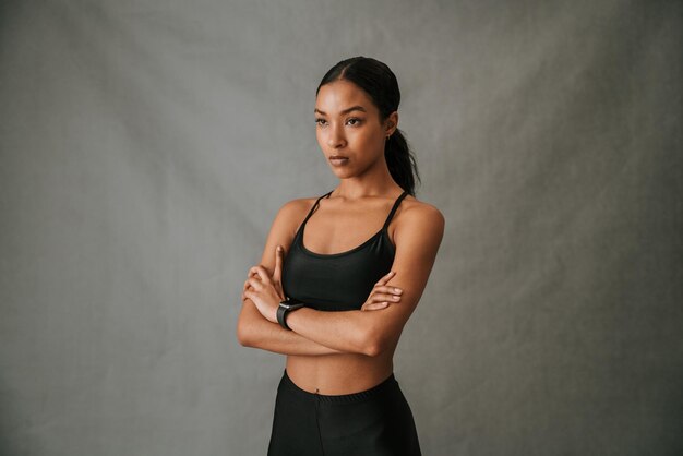 Serious multiethnic female standing crossed arms in the studio