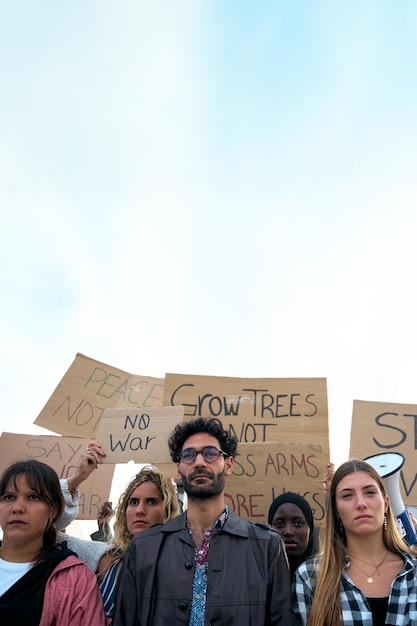 Serious multiracial group demonstrating against the war and violence in the world people gathered