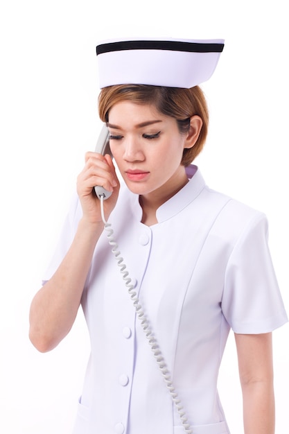 Serious nurse working, listening the phone call