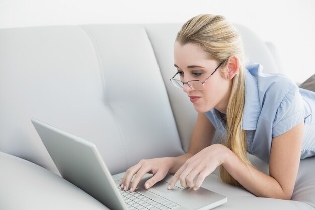 Serious peaceful businesswoman working on laptop 