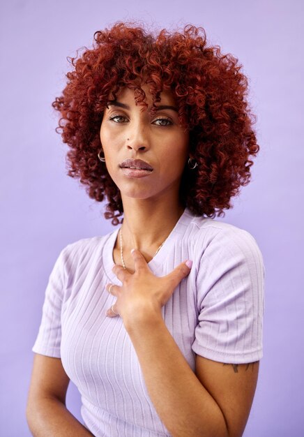 Serious portrait and african woman with fashion natural beauty and gen z confidence on purple background in studio dermatology face and model with pride style and pose for cosmetics or skincare