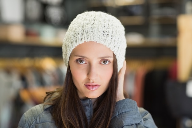 Serious pretty brunette looking at camera with winter clothes