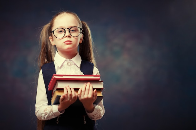 Serious Schoolgirl Wear Glasses Hold Pile of Book. 