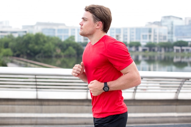 Serious Sporty Young Man Running Outdoors