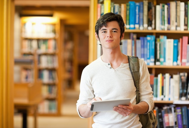 Serious student holding a tablet computer