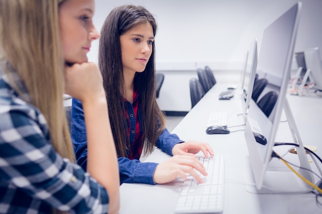 Serious students working on computer at university 