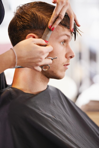 Serious style Cropped shot of a young man having his hair cut by a stylist