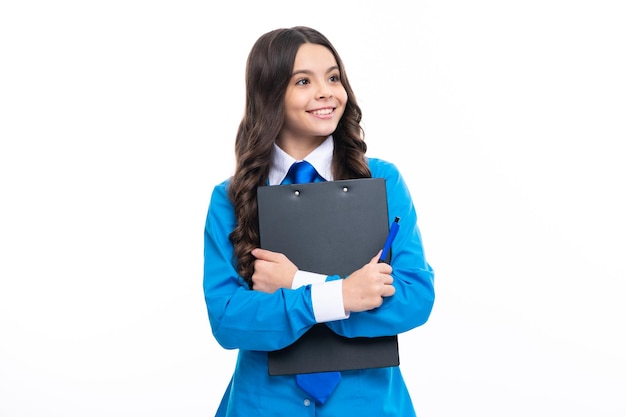 Serious teenager girl in shirt and tie wearing office uniform holding clipboard on white isolated background