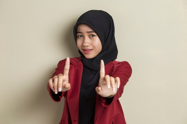 Serious upset asian muslim woman showing stop hand gesture