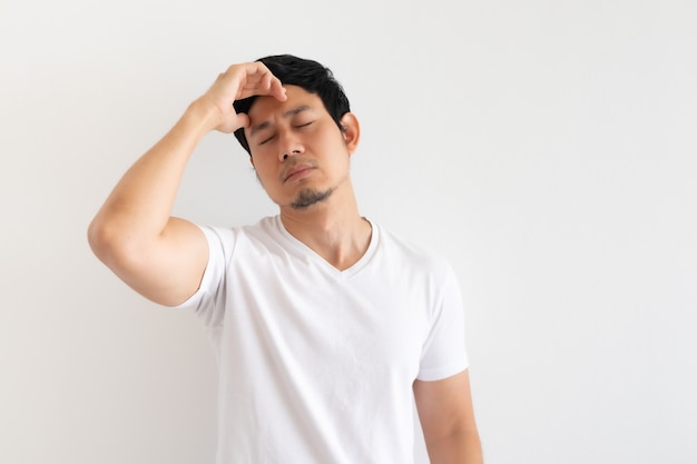 Serious and upset man wears white t-shirt isolated on white background.