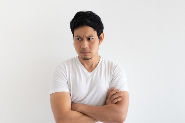 Serious and upset man wears white tshirt isolated on white background