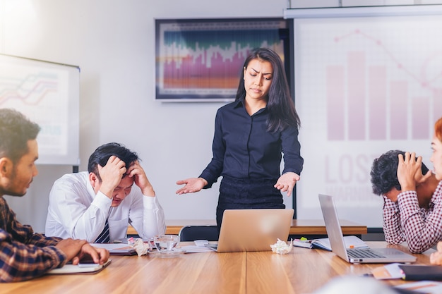 Serious woman boss scolding marketing team employee for bad business result in meeting