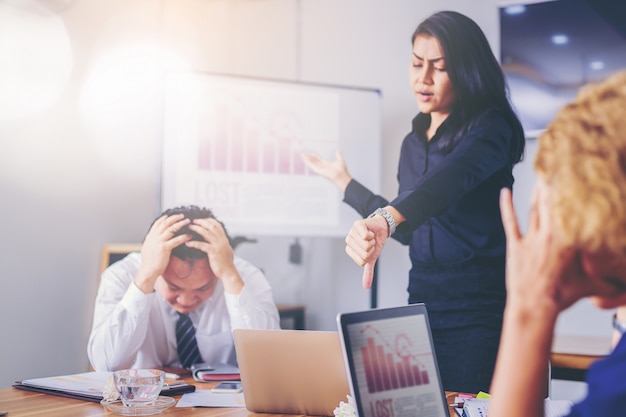 Serious woman boss scolding marketing team employee for bad business result