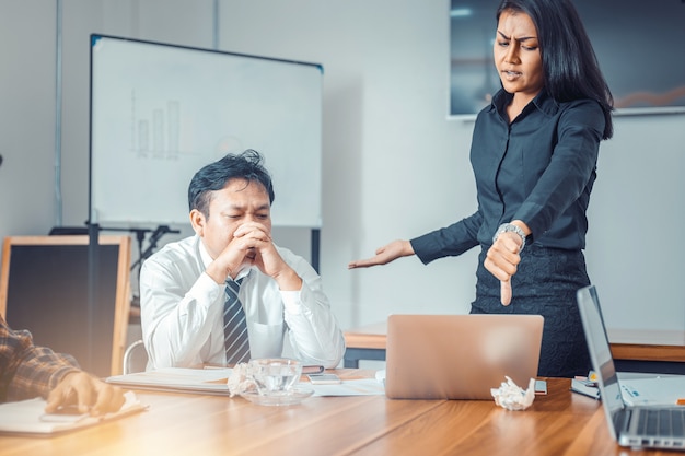 Serious woman boss scolding marketing team employee for bad business result 