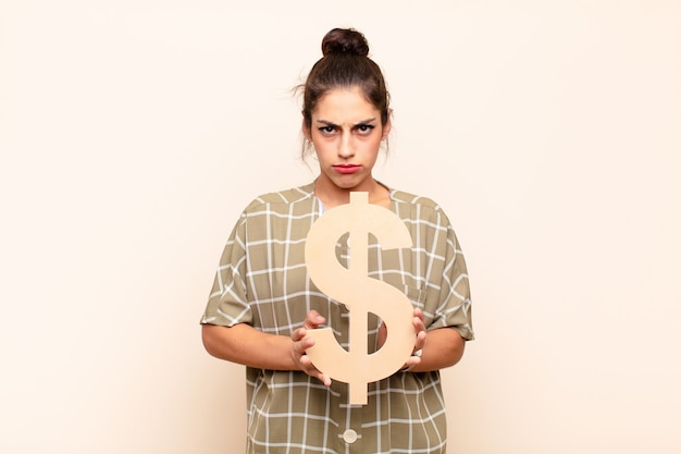 Photo serious woman holding the dollar symbol