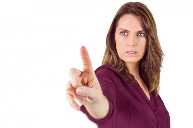 Serious woman pointing her finger at camera 