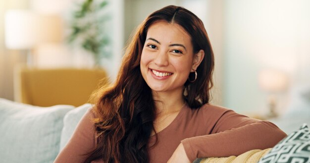 Photo serious woman relax and home with a beautiful asian female feeling calm peaceful and enjoying her free time on the sofa at home portrait and face of a young female sitting in her singapore house