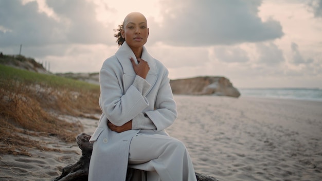 Serious woman thinking ocean beach alone frustrated african american posing