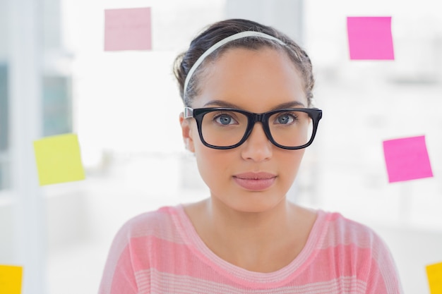 Serious woman with glasses in creative office