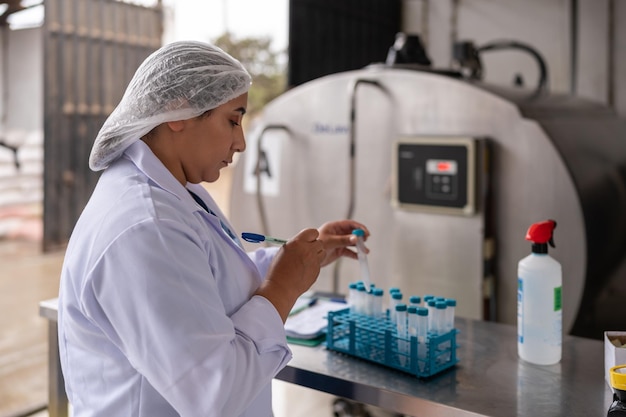 Foto donna seria che lavora in un laboratorio di un caseificio