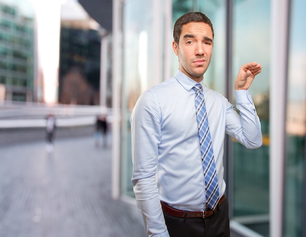 Serious young businessman asking for silence