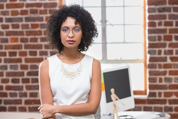 Serious young businesswoman in office