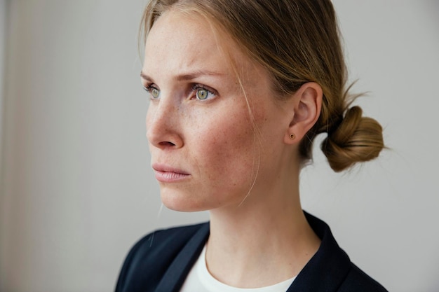 Serious young businesswoman thinking