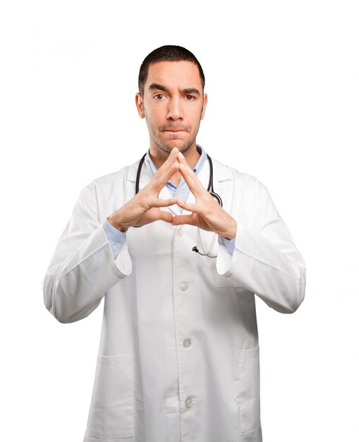 Serious young doctor doing a concentration gesture