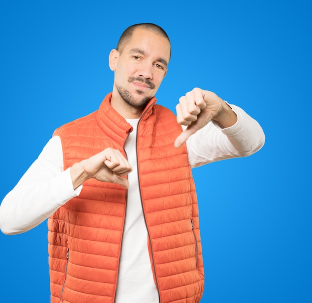 Serious young man doing a gesture of defeated