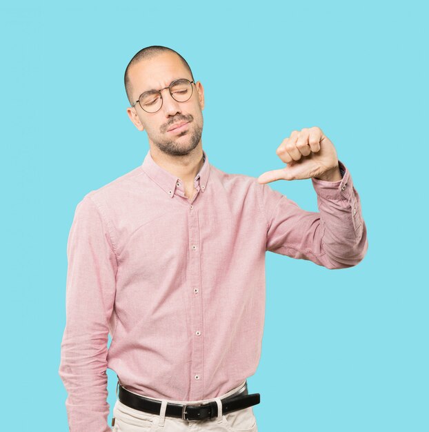 Serious young man doing a gesture of defeated