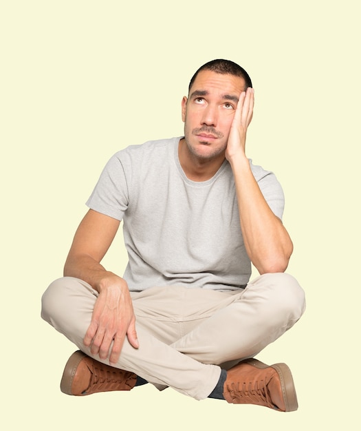 Serious young man looking against background