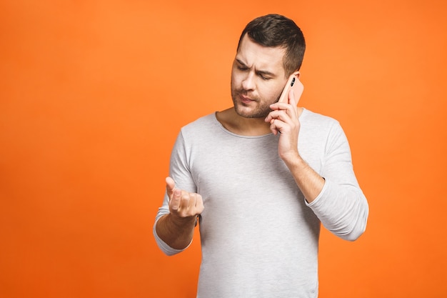 Serious young man talking on mobile